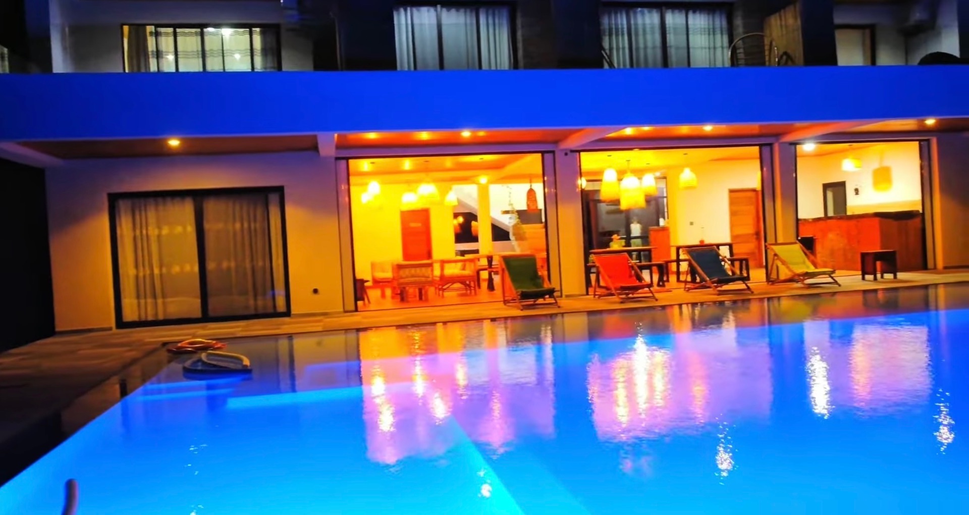 The villa and pool lit up after dark